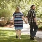 Rexford looking back while walking and holding Jaclyn's hand