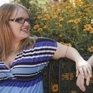 Sitting apart on a bench and holding hands